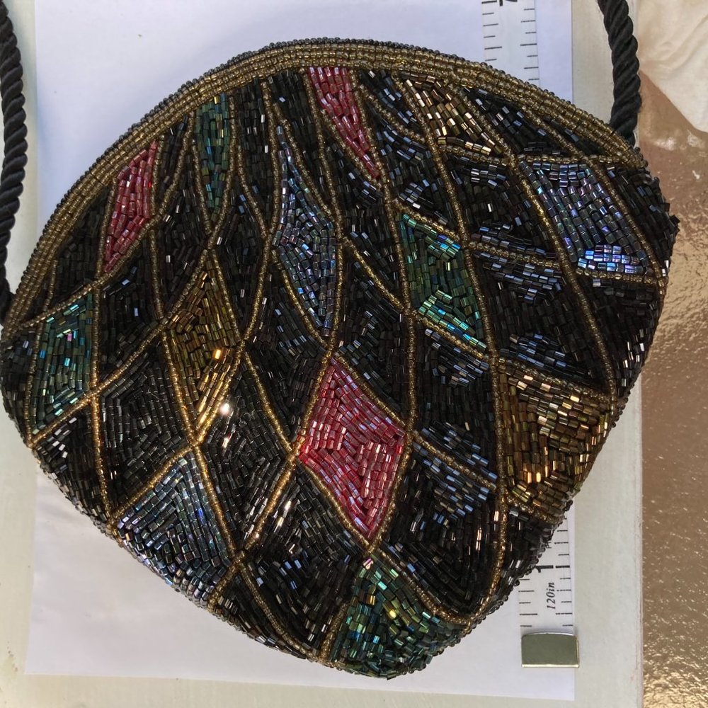 Shell-shaped, harlequin colored beaded evening purse with long cord